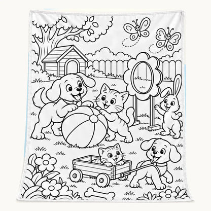 Animal backyard coloring blanket with dogs, cats, a rabbit, butterflies, a ball and wagon in black-and-white outlined artwork.