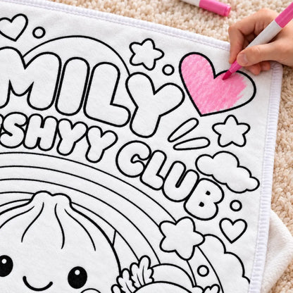 Close-up of a pink marker coloring a heart on the Squishy Club doodle blanket.