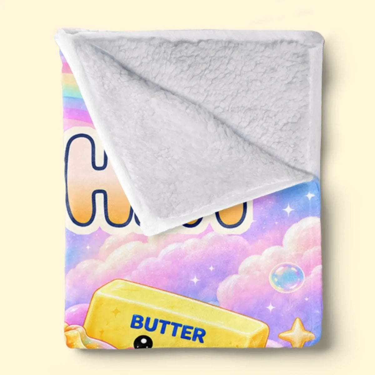 Folded rainbow name blanket showing textured white reverse