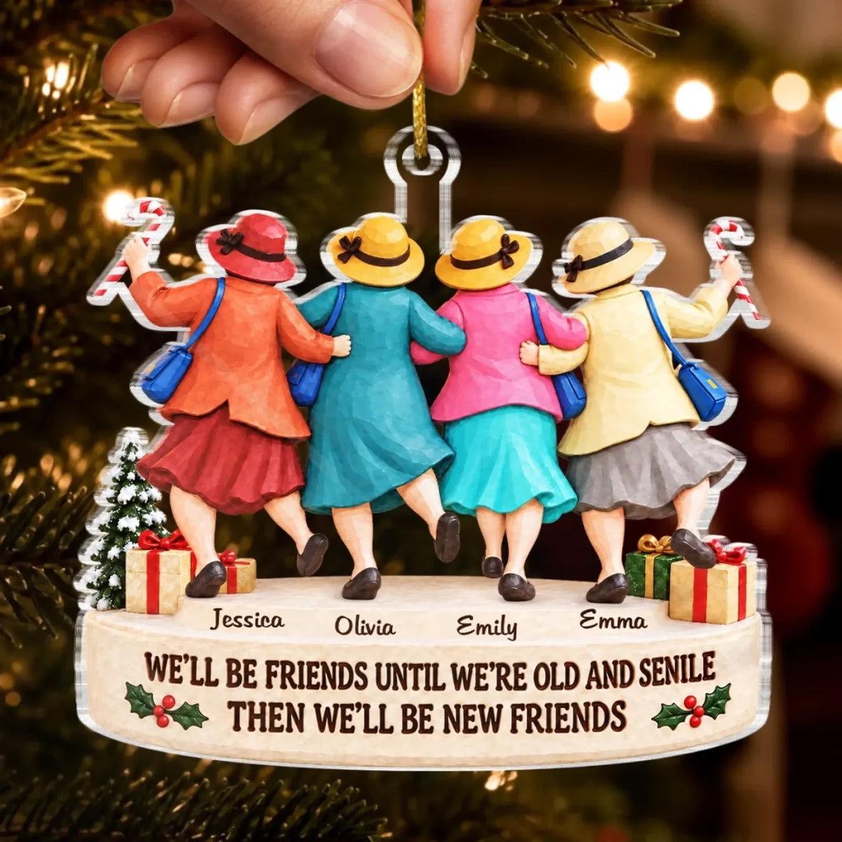 Hand holding four-friends Christmas ornament with names