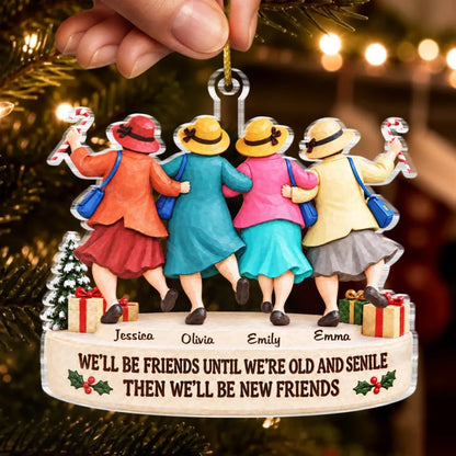 Hand holding four-friends Christmas ornament with names