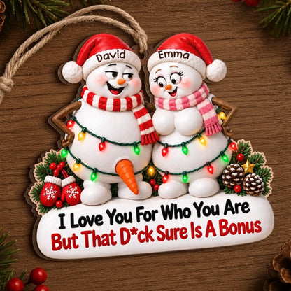 Snowman couple wooden ornament displayed on wood