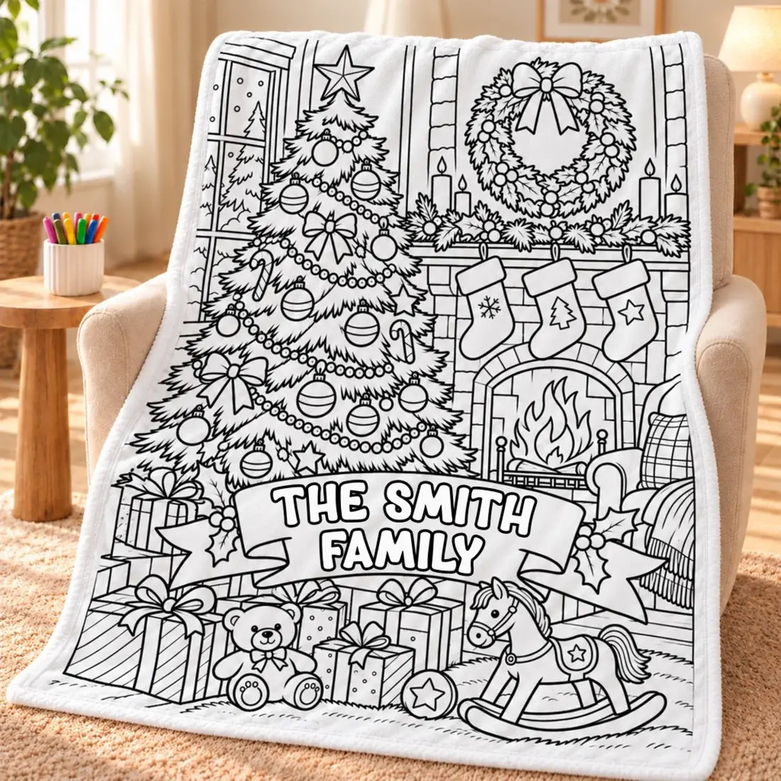 Christmas family-name doodle blanket draped over an armchair beside a cup of markers