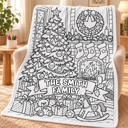 Christmas family-name doodle blanket draped over an armchair beside a cup of markers