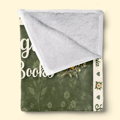 Folded floral storytime blanket showing white textured Sherpa backing
