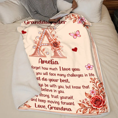 Custom initial Floral Love blanket draped across a reader on a sofa