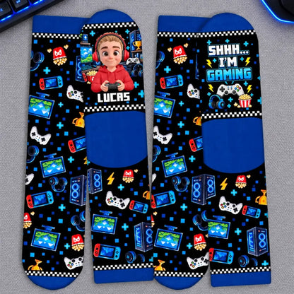Flat-lay gamer crew socks showing the personalized name design, heels and printed soles