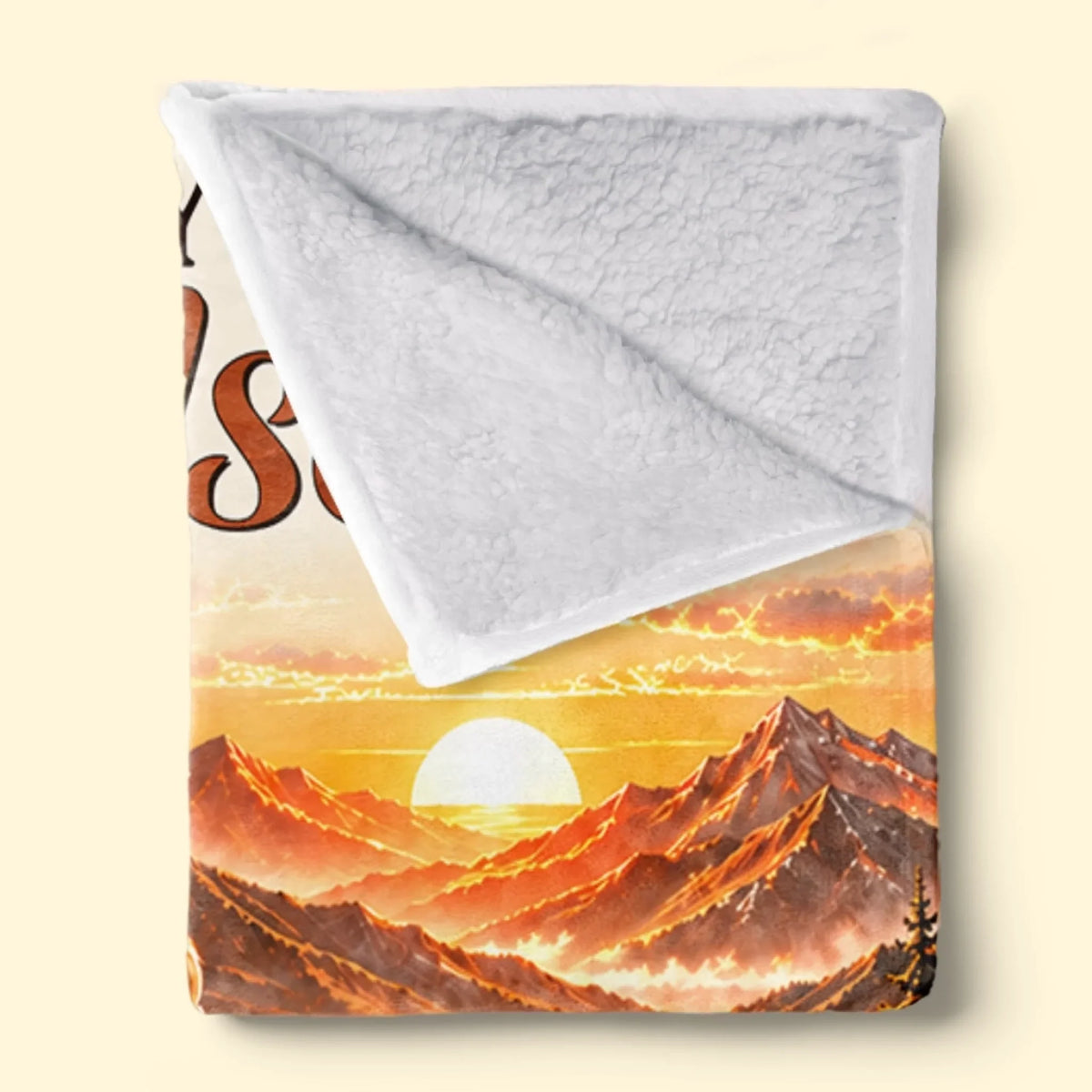 Folded grandson blanket showing white textured Sherpa backing