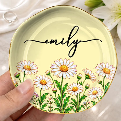 Pale yellow lace-circle jewelry dish with daisies and the name Emily, held in one hand