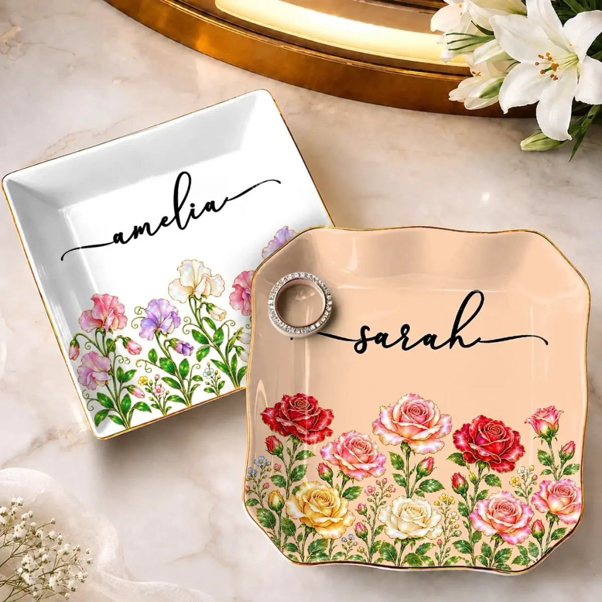 Square white and scalloped peach floral name jewelry dishes displayed together