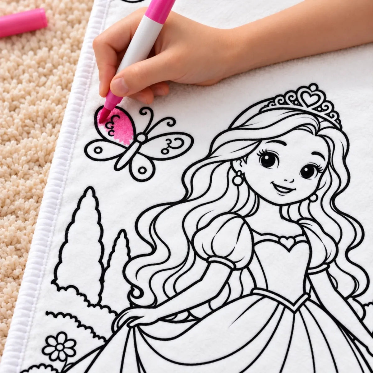 Close-up of a pink marker coloring a butterfly on a princess doodle blanket