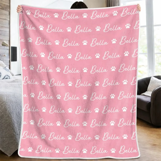 Pink paw-print blanket with repeated example name Bella