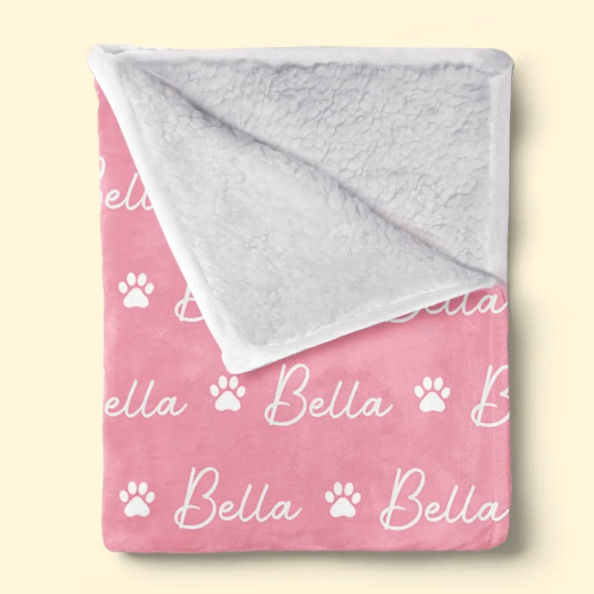 Sherpa-style backing on a folded paw-print name blanket