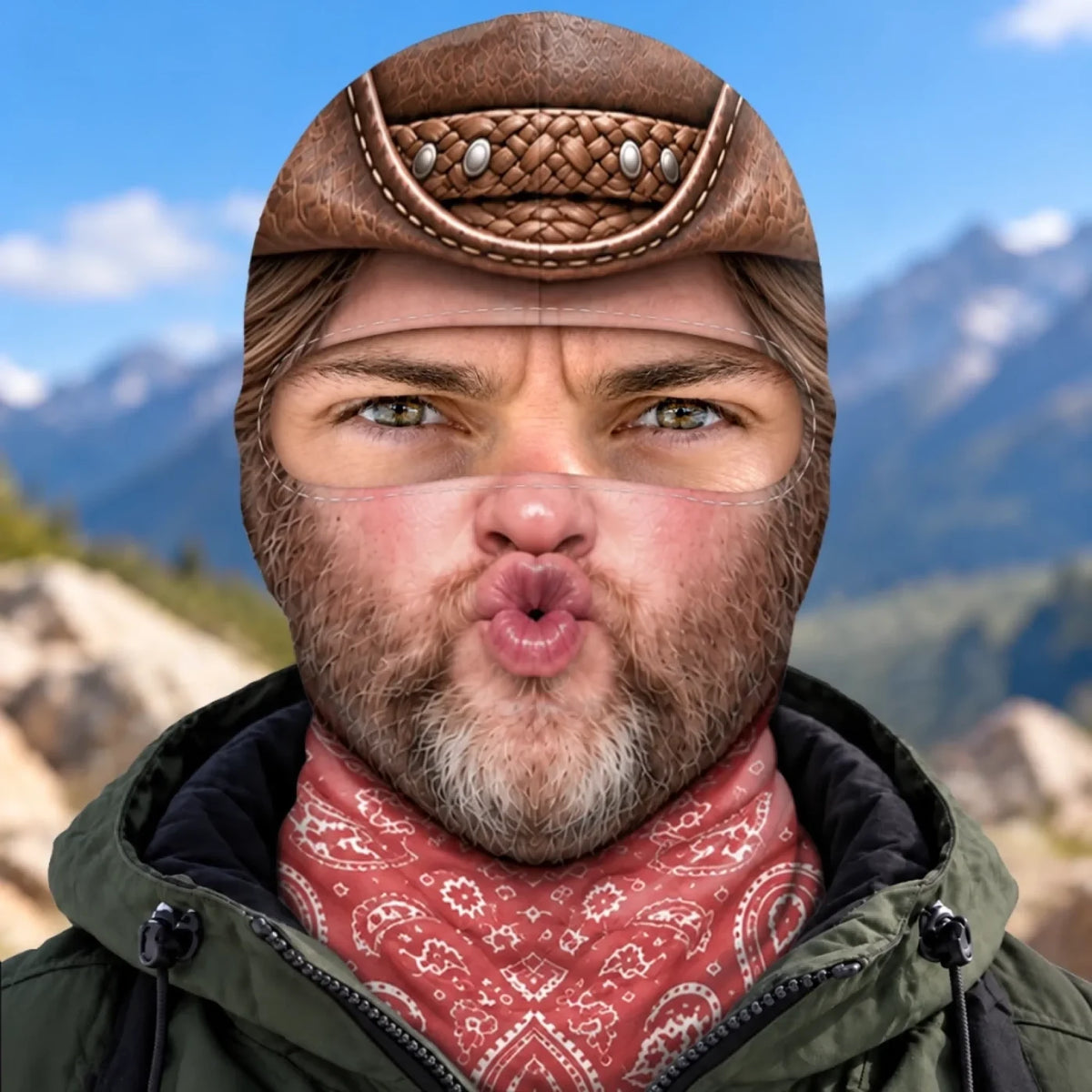 Front view of puckered cowboy face balaclava with printed brown hat, beard and red bandana.