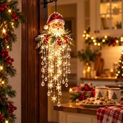 Santa Claus hanging light glowing beside a Christmas cookie and cocoa corner