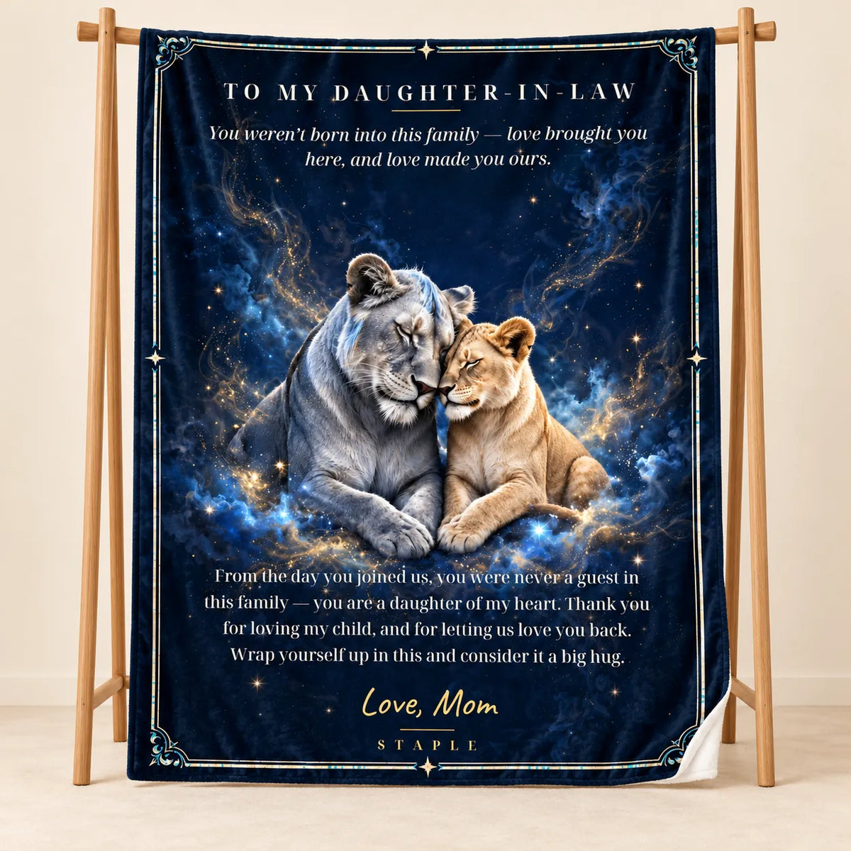 Illustrative studio mockup of To My Daughter-in-Law velveteen blanket with Love, Mom message, on wooden stand with white reverse corner.