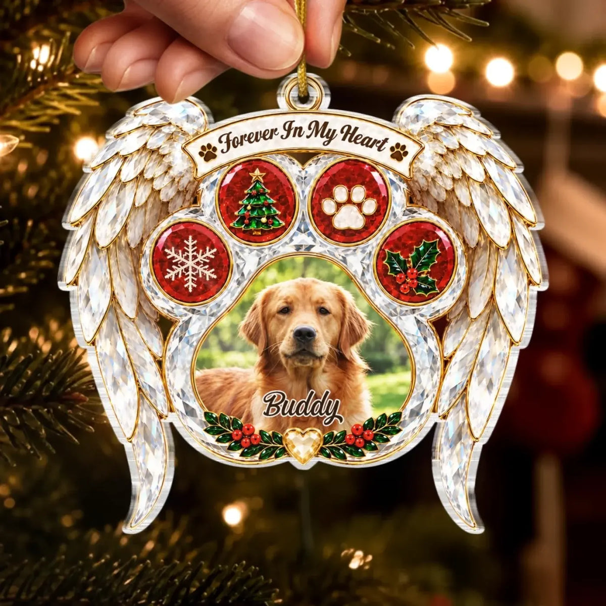 Hand holding an angel wing pet memorial ornament with a dog photo and Forever In My Heart message.
