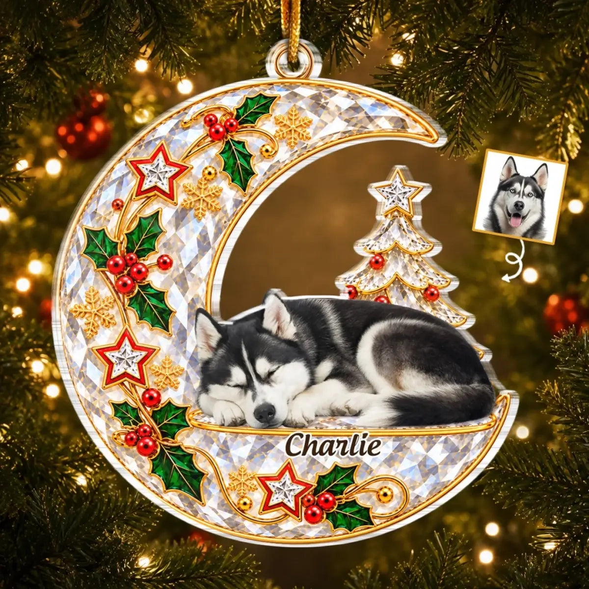 Crescent moon pet memorial ornament with a sleeping husky portrait, Charlie name, holly and Christmas tree, hanging on a tree.