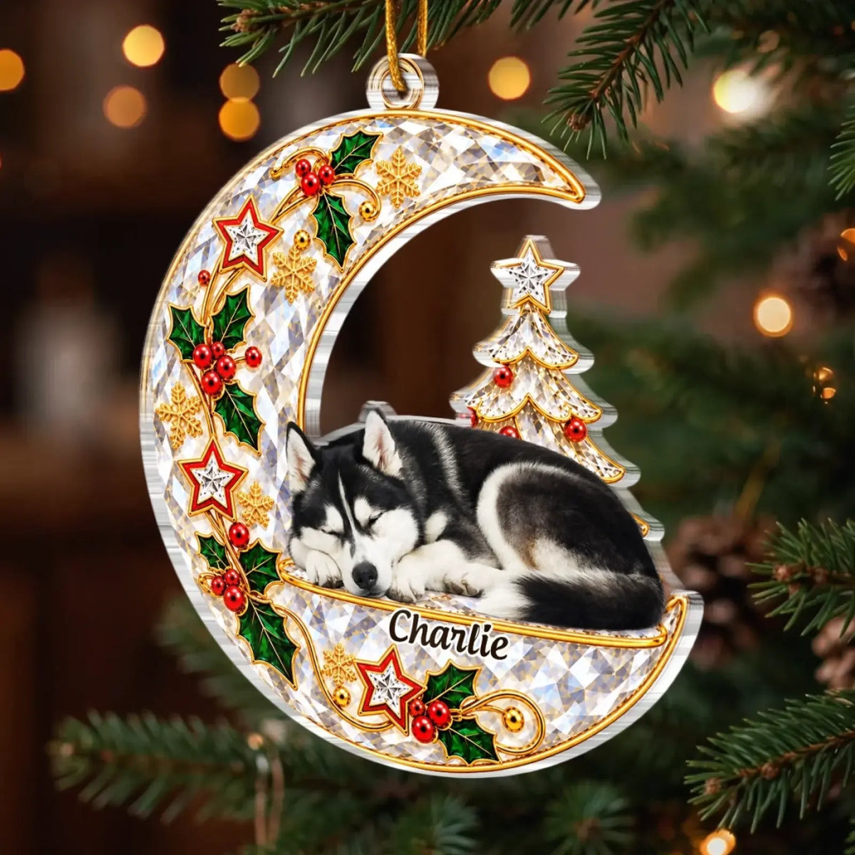 Moon-shaped pet memorial ornament with a sleeping husky portrait and Charlie name among evergreen branches.