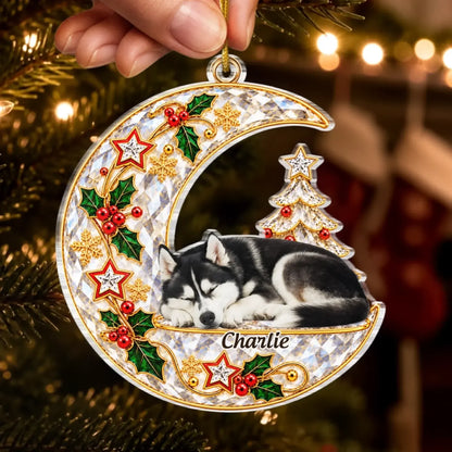 Hand holding a crescent moon pet memorial ornament with a sleeping husky portrait and Charlie name.
