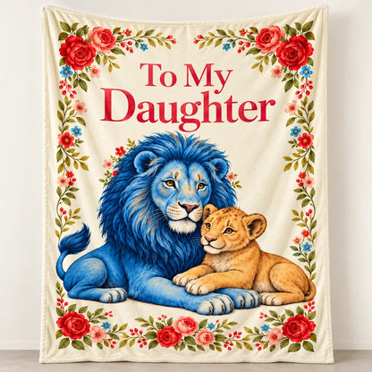 Illustrative To My Daughter blue lion floral blanket, with a blue father lion and golden cub on a cream background framed by red and pink flowers.